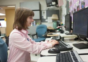 Woman working at a computer.