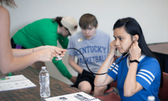 Woman listening with a stethoscope